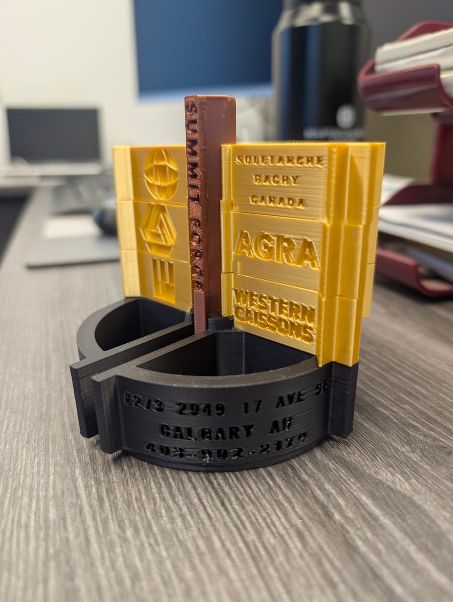 Custom 3D-printed desk organizer built around a customer's trade, equipment lineage, and shop branding.